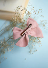 Load image into Gallery viewer, An image of a Daisy delight knot Hairclip with a brown clip for girls, with an open book on a light blue background-Hair accessories.