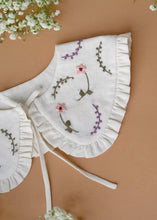 Load image into Gallery viewer, A beautiful detachable victorian style collar with subtle hand embroidery for kids kept on light peach background with some flowers aside.