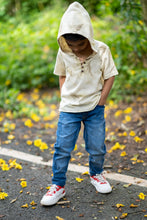 Load image into Gallery viewer, A kid posing in the middle of the street wearing a unisex hooded kurta eco-printed using silver oak leaves.