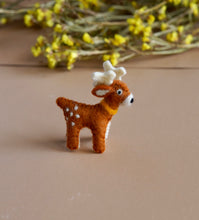 Load image into Gallery viewer, A beautiful handmade deer toy kept upon a peach background with some flowers aside.