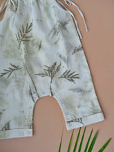 Load image into Gallery viewer, A beautiful unisex jumpsuit with wild silver oak design on it which is kept upon a peach background with some leaves aside.