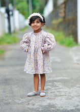 Load image into Gallery viewer, A kid wearing dreamy fairy lavender baby girl dress with a white head band and posing in between the street.