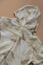 Load image into Gallery viewer, A unisex hooded kurta eco-printed using silver oak leaves kept upon a peach background.