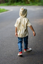 Load image into Gallery viewer, A kid walking in the middle of the street wearing a unisex hooded kurta eco-printed using silver oak leaves.