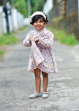 Load image into Gallery viewer, A kid wearing dreamy fairy lavender baby girl dress with a white head band and posing in between the street.