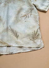 Load image into Gallery viewer, A unisex hooded kurta eco-printed using silver oak leaves kept upon a peach background.