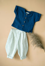 Load image into Gallery viewer, Indigo kurta and balloon pants for boys kept on a peach background with some flower aside.