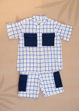 Load image into Gallery viewer, A set of Handwoven Cotton Co-ord set with Patch Pocket kidswear with indigo checkmate design kept on a beige background