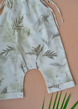 Load image into Gallery viewer, An organic cotton jumpsuit eco-printed with silver oak leaves with some leaves aside.