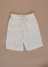Load image into Gallery viewer, A white coloured Organic Cotton Cargo Shorts kidswear kept on a biege coloured background