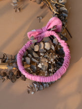 Load image into Gallery viewer, Beautiful baby hair accessories of headband with bow clip kept upon a dried leaf.