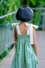 Load image into Gallery viewer, A girl wearing elegant and beautiful secret fairy pocket dress with white headband and holding a toy by posing by turning her back.