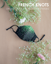 Load image into Gallery viewer, A colourful French knots organic cotton adjustable masks with some toy and flower aside.