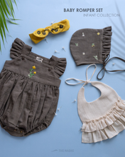 Load image into Gallery viewer, It is an organic baby romper set which has four pieces in total kept upon a blue background with some leaf aside.