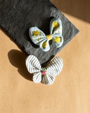 Load image into Gallery viewer, A very cute and beautiful butterfly combo hair accessory placed upon a grey sheet.