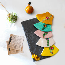 Load image into Gallery viewer, A beautiful colouful organic embroidery face masks kept on a grey sheet with some cards, flower and toy aside.