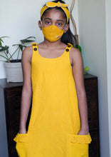 Load image into Gallery viewer, A girl wearing beautiful extendable shift dress, matching mask and matching hair accessory.
