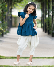 Load image into Gallery viewer, A young girl posing by wearing elegant blue flutter sleeve top and cream balloon pant with blur background.