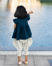 Load image into Gallery viewer, A young girl pointing towards swimming pool by wearing elegant blue flutter sleeve top and cream balloon pant with blur background.