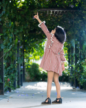 Load image into Gallery viewer, A girl wearing beautiful lace shift dress with matching accessory pointing her hand towards sky and posing in the middle of the road.