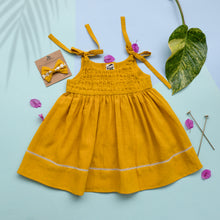 Load image into Gallery viewer, A beautiful adjustable shoulder strap dress with matching hair accessory kept upon a blue background with some leaf petals, long pins and leaf aside.