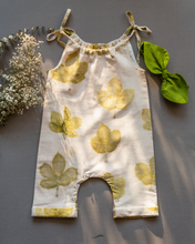 Load image into Gallery viewer, A cute baby girl dress made of eco-printed Indian maple leaves on it along with matching hair accessory and some flower aside.