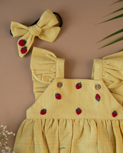 Load image into Gallery viewer, A cute romper with some strawberry embroidery on it with matching hair accessory, some leaf and flower aside.