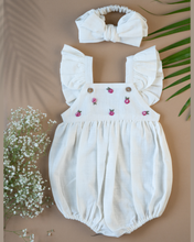 Load image into Gallery viewer, A cute romper with some flower embroidery on it with matching hair accessory, some leaf and flower aside.