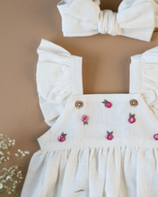 Load image into Gallery viewer, A cute romper with some flower embroidery on it with matching hair accessory and flower aside.