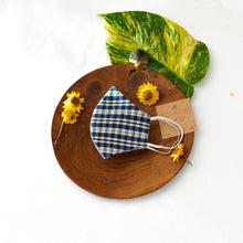 Load image into Gallery viewer, A beautiful, patterned face mask kept upon a round wooden log with some flower, leaf, toys and cards aside.