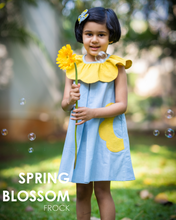 Load image into Gallery viewer, A girl holding flower and posing it by wearing a beautiful dress with petal detailing's around the neck and pockets.