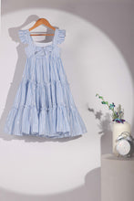 Load image into Gallery viewer, Light blue striped dress on a hanger with a decorative clock and flowers in the background.

