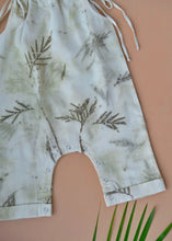 Load image into Gallery viewer, An organic cotton jumpsuit eco-printed with silver oak leaves with some leaves aside.
