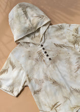 Load image into Gallery viewer, A unisex hooded kurta eco-printed using silver oak leaves kept upon a peach background.
