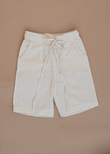 Load image into Gallery viewer, A white coloured Organic Cotton Cargo Shorts kidswear kept on a biege coloured background

