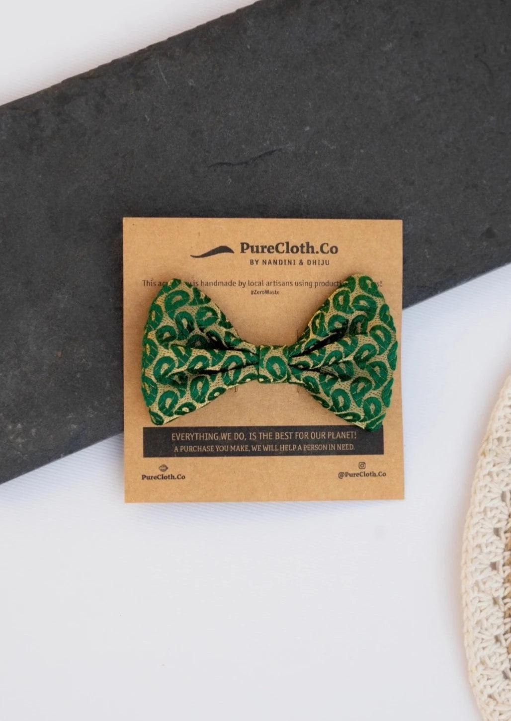 A beautiful Green Silk Hair Clip for hair accessories with branding of PureCloth.Co Placed on a white and black background