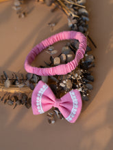 Load image into Gallery viewer, Beautiful baby hair accessories of headband with bow clip kept upon a dried leaf.

