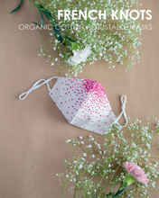 Load image into Gallery viewer, A colourful French knots organic cotton adjustable masks with some toy and flower aside.
