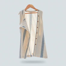 Load image into Gallery viewer, A beautiful white A-line shift dress with flattering vertical blue stripes and laced hemline is hanged using hanger.
