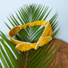 Load image into Gallery viewer, An extendable hair accessory kept upon leaf and wood.
