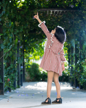 Load image into Gallery viewer, A girl wearing beautiful lace shift dress with matching accessory pointing her hand towards sky and posing in the middle of the road.
