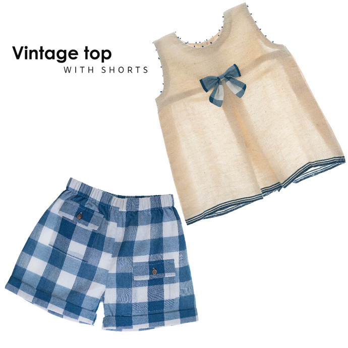 A beautiful white front inverted pleat and tiny handcrafted French knots running across shoulders with the classic blue checkered short.